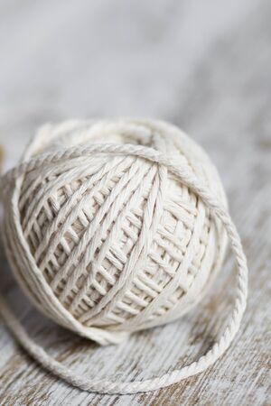 Natural fiber rope balls over a wooden backgroundの写真素材