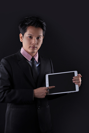 Portrait of Asian young man on black backgroundの写真素材