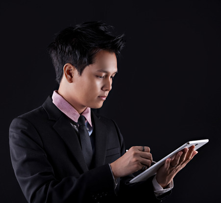 Portrait of Asian young man on black backgroundの写真素材