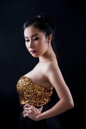 Portrait of beautiful Asian young girl on black backgroundの写真素材