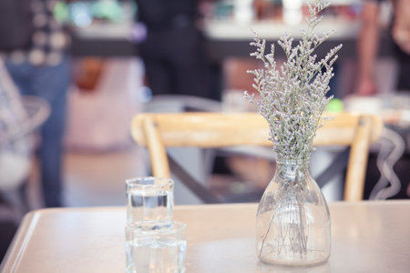 flower in Glass vase on dinning table with vintage filter