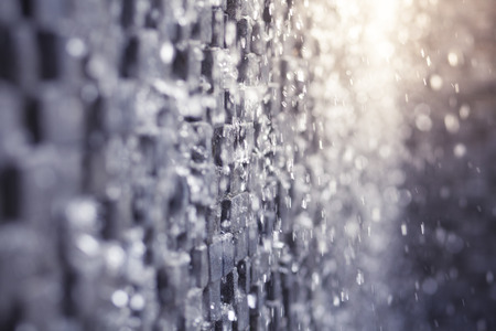 Abstract background of water fall on cube wall with bokeh and copy spaceの写真素材