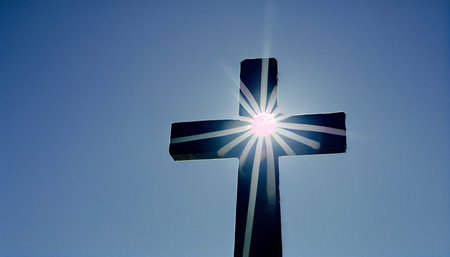Cross in the blue sky with sunbeams and lens flare.の素材