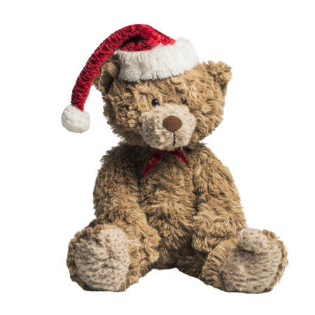 A brown teddy bear wearing a red Santa hatの素材