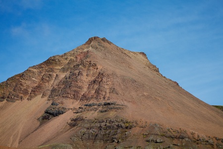 Brown mountain with loose stones on the sidesの写真素材