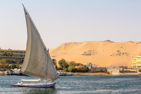 Sailboat on the Nile river at the shore of Aswan, Egyptの写真素材