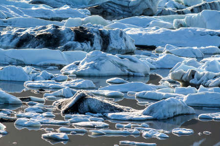 Ice floes in the Fjallsarlon glacial lake on a summer evening, Icelandの写真素材