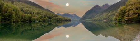 Tranquil lake Gunn in Fiordland National Park, landscape reflecting on the water surface, South Island of New Zealandの写真素材
