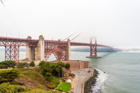 Scenic Golden Gate Bridge in the fog from Fort Poin, San Francisco, USAの写真素材