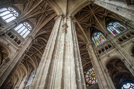 Tall columns and beautifully ornate ceiling in the gothic church Saint Eustache in Paris, Franceのeditorial素材