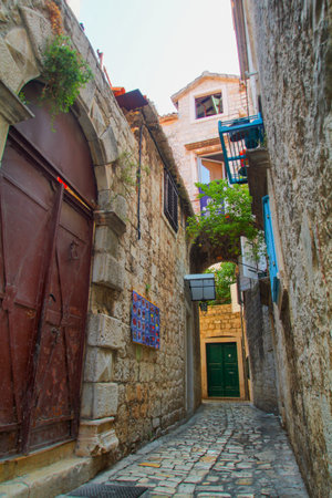 Scenic narrow, typical mediterranean alley in downtown Trogir, Croatiaの写真素材