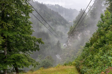 Scenic mountain landscape and a cable car near Garmisch-Partenkirchen, clouds and rain cover the view, Germanyの写真素材