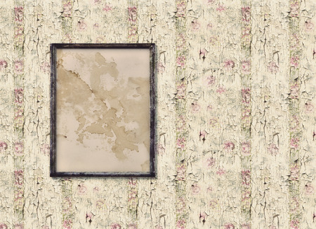 Old picture frame on an old vintage wallの写真素材