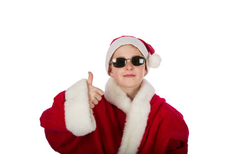 a young boy as Santa Claus with thumb upの写真素材