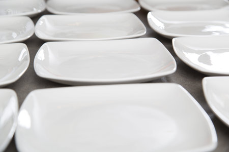 white square plates arranged on a table