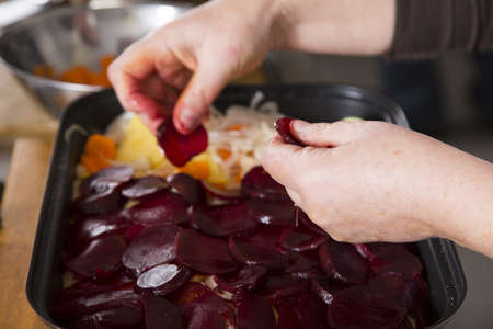 preparing a casserole with beetroot and potatoesの写真素材