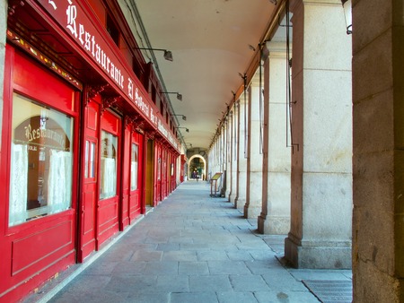 Red bar facade at Plaza Mayor Square - Madrid, Spain. Plaza Mayor Square is located in downtown Madrid and itâs a major symbol for the city. It was constructed in the beginning of the 17th century during the Baroque artistic period.  It has a rectangulaのeditorial素材