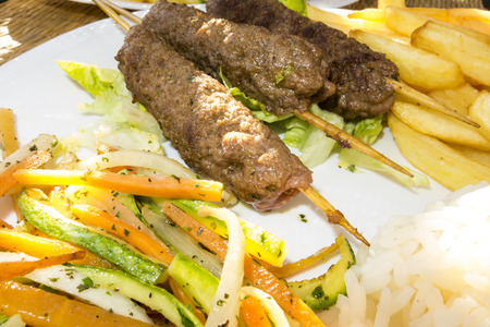 View of a plate with traditional cuisine from Marrakesh.  Specifically, skewers of Lamb, also known for Kebabs.の写真素材