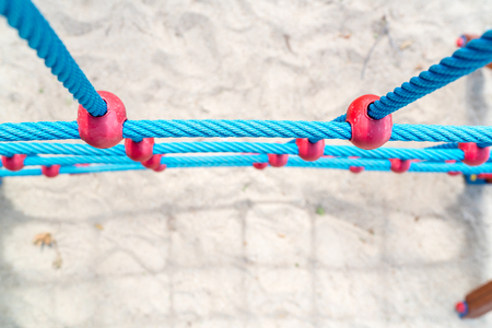 Above view of blue ropes of climbing wall against of sand ground.Playground.の写真素材