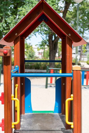 View of children playground with empty slide under rooftopの写真素材