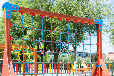 View of bright climbing wall made of ropes and wood frame at playgroundの写真素材