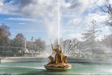 View of ancient fountain with beautiful golden statue of  Empress on throne in European parkの写真素材