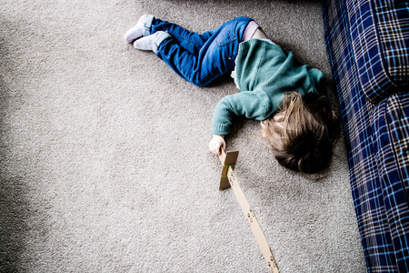 A defeated knight, also known as a young kid with a cardboard sword.の写真素材