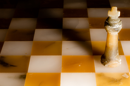 The black king on a stone chessboardの写真素材