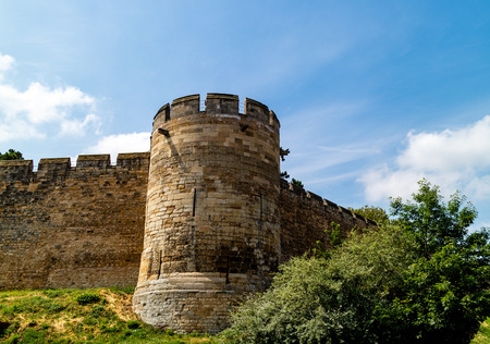 Lincoln, United Kingdom - 07/21/2018: Lincoln Castle wall during the day. Lincoln Castle is an old Norman castle built on the pre-existing remains of a Roman one. It is only one of two of it's kind in the UK as it has two mottes.のeditorial素材