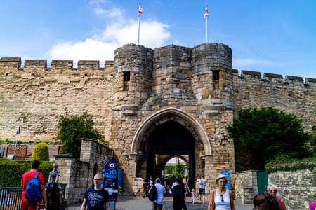 Lincoln, United Kingdom - 07/21/2018: Lincoln Castle during the day with tourists. Lincoln Castle is an old Norman castle built on the pre-existing remains of a Roman one. It is only one of two of it's kind in the UK as it has two mottes.のeditorial素材