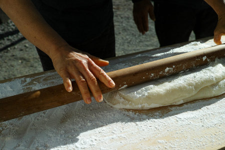 Mochi being rolled flat, before being separated into balls for the new year