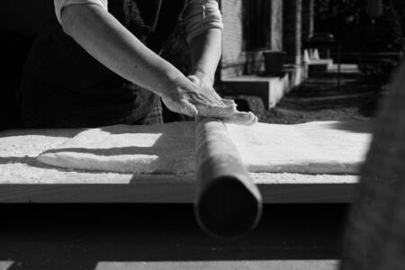 Mochi being rolled flat, before being separated into balls for the new yearの写真素材