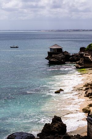 beautiful coastal scenery with a wooden hut perched out at seaの写真素材