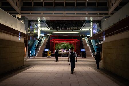 Tokyo, Japan - 26 5 2018: A police officer walking through Haneda airport at nightのeditorial素材