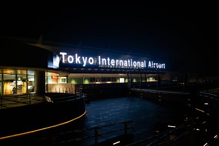 Tokyo, Japan - 26 5 2018: The sign for Tokyo International Airport at Haneda, at night.のeditorial素材