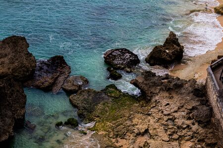 Sea swirling near the coastline and rock formationsの写真素材