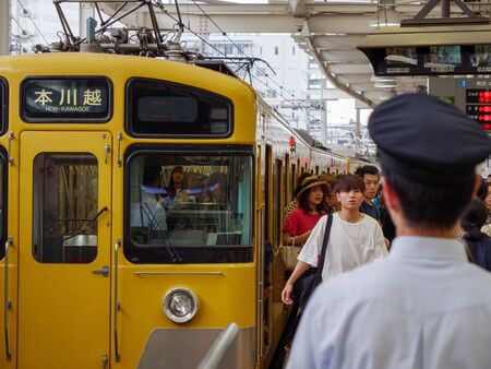 Shinjuku, Japan - 2 9 19: The seibu-shinjuku line train pulling into a busy station.のeditorial素材