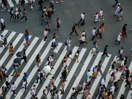 Shibuya, Japan - 23 9 19: People Crossing Shibuya Crossing in the evening with the full crossing in...