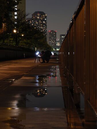 High rise buildings reflected in the rain in Tokyoの写真素材