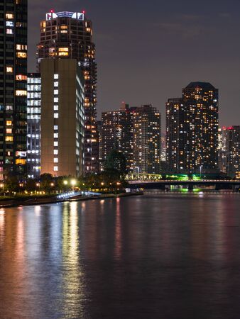 High rise buildings in Tokyo reflected in a riverの写真素材