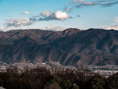 Sweeping views of a small Japanese town surrounded by mountains.の写真素材