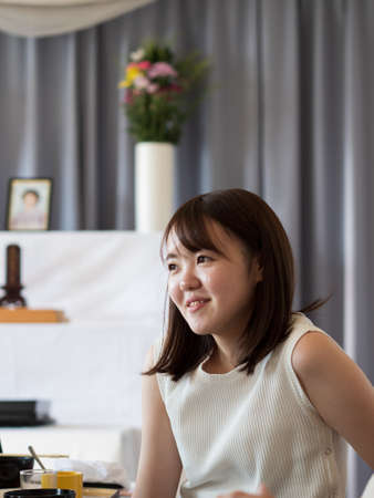 a young woman talking happily while attending an event dinnerの写真素材