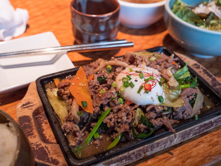 A Korean main course with beef and egg topping riceの写真素材