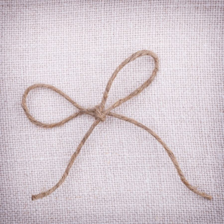 A bow tie on fabric vintage backgroundの写真素材