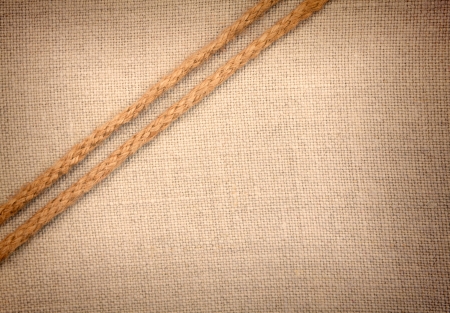 Two ropes going diagonally  on fabric vintage backgroundの写真素材