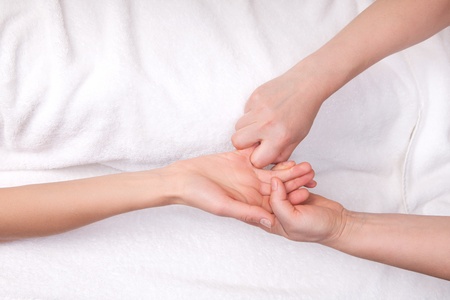Spa therapist doing relaxing massage on a woman's little fingerの写真素材