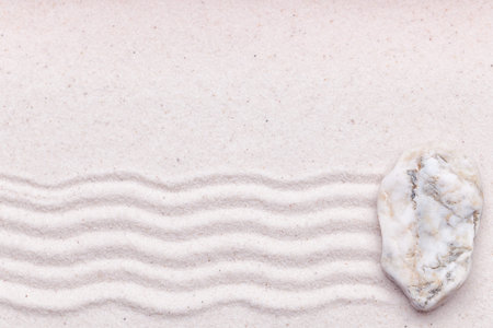 a white marble rock and wave pattern on the sand