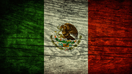 The national vintage flag of Mexico on wooden surfaceの写真素材
