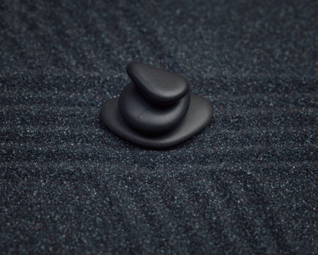 Black pebbles on a raked sand