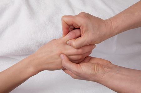 Professional  therapist doing chinise hand massage on the index fingerの写真素材